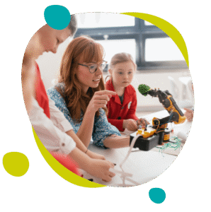 A computing and tech instructor showing children how to program a robot